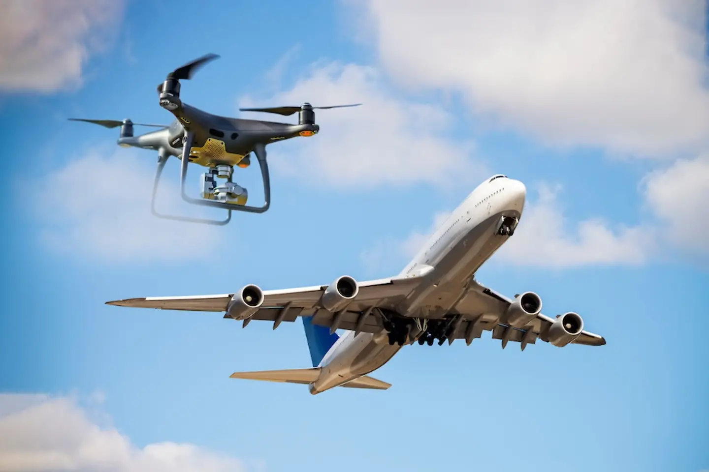 Drone in the sky in front of an airplane