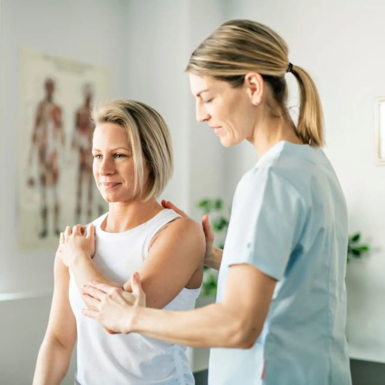Nurse helping patient with physiotherapy and digital tools