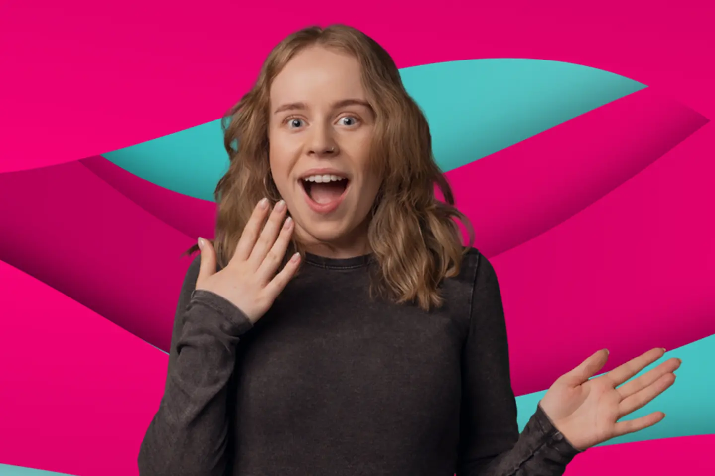 Young woman looking happily surprised 
